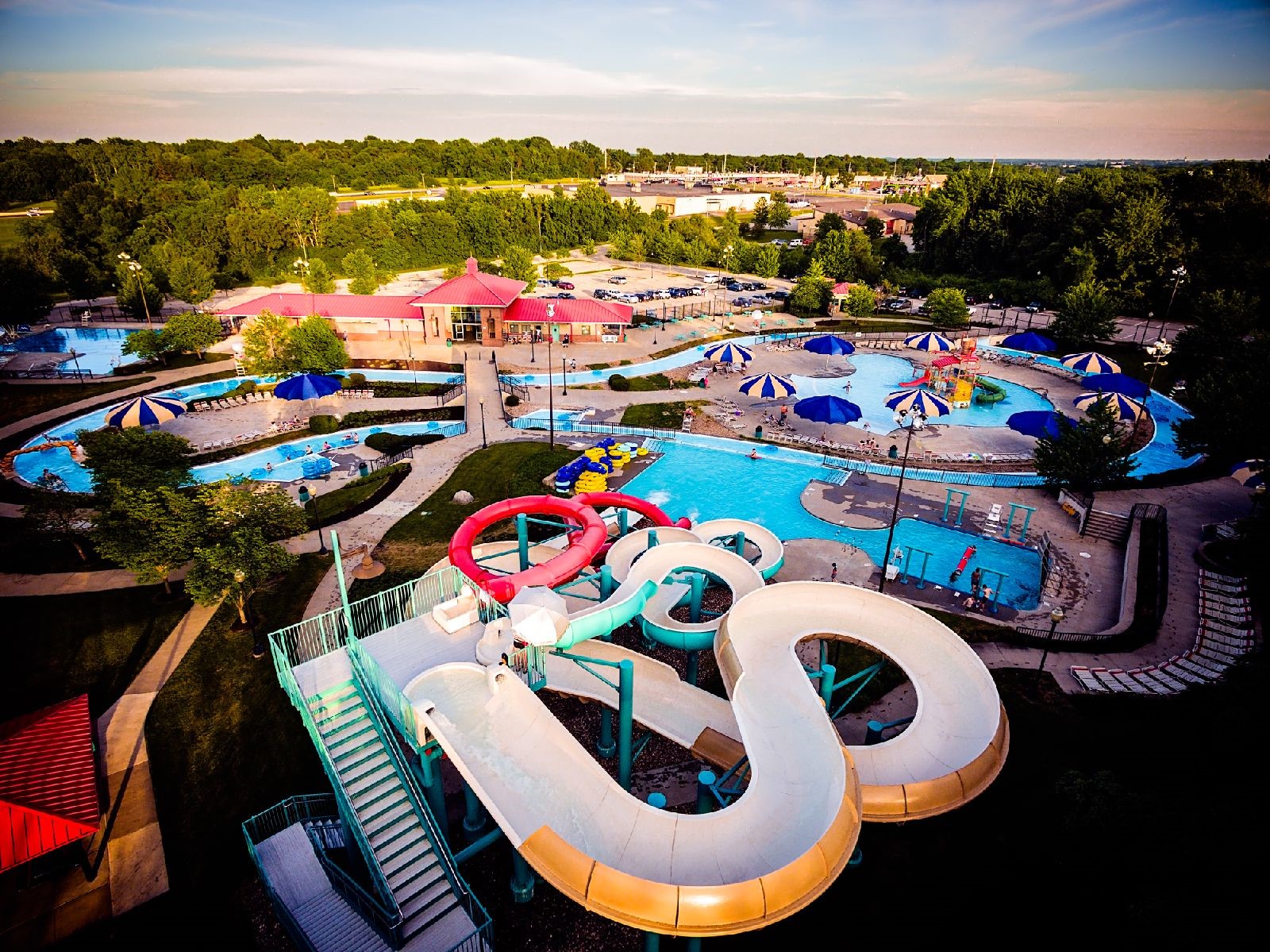 An areal image of the Adventure Oasis Water park at dusk showing different pools and water slides. 