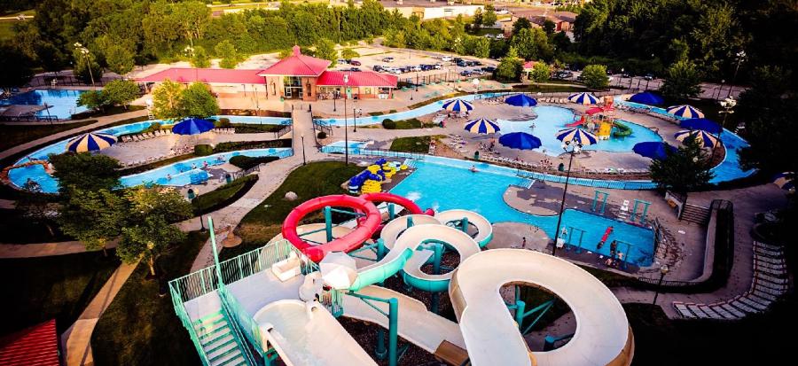 An areal image of the Adventure Oasis Water park at dusk showing different pools and water slides. 