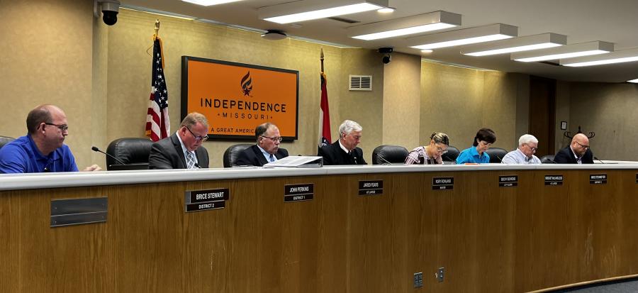 The seven members of the City Council and City Clerk sit behind the dais in the Council Chambers of Independence City Hall. 