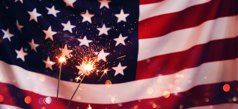 Photo of the American flag with sparklers in front of it