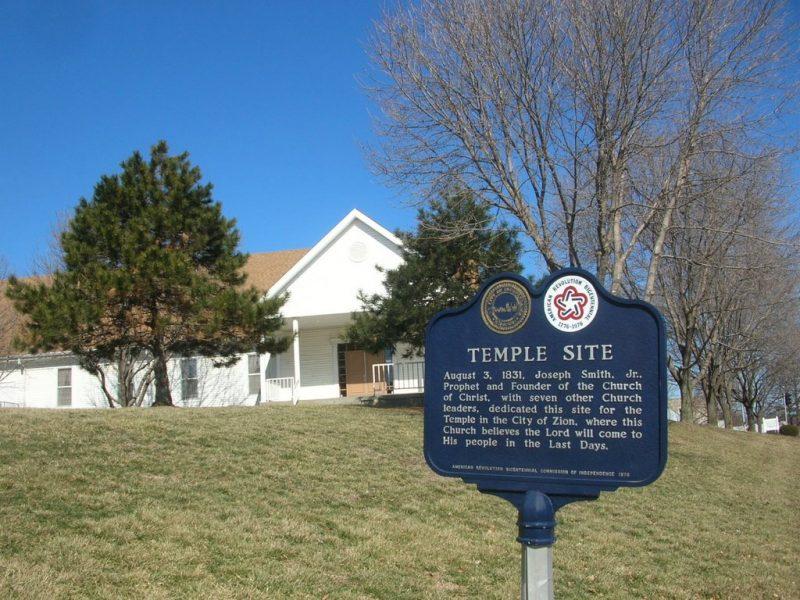 Historic marker of Temple Lot in foreground and grass in the background.