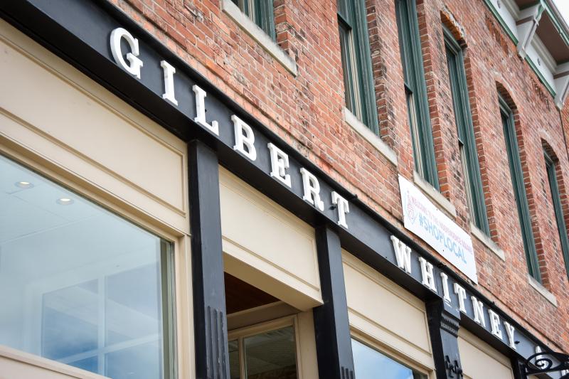 Gilbert and Whitney sign on exterior of building